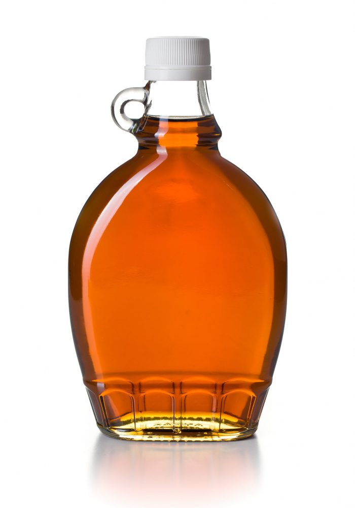 maple syrup in glass bottle on white background