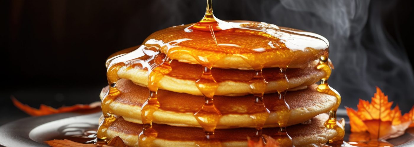 close-up of hot steaming pancakes with maple syrup on a cold morning, created with generative ai